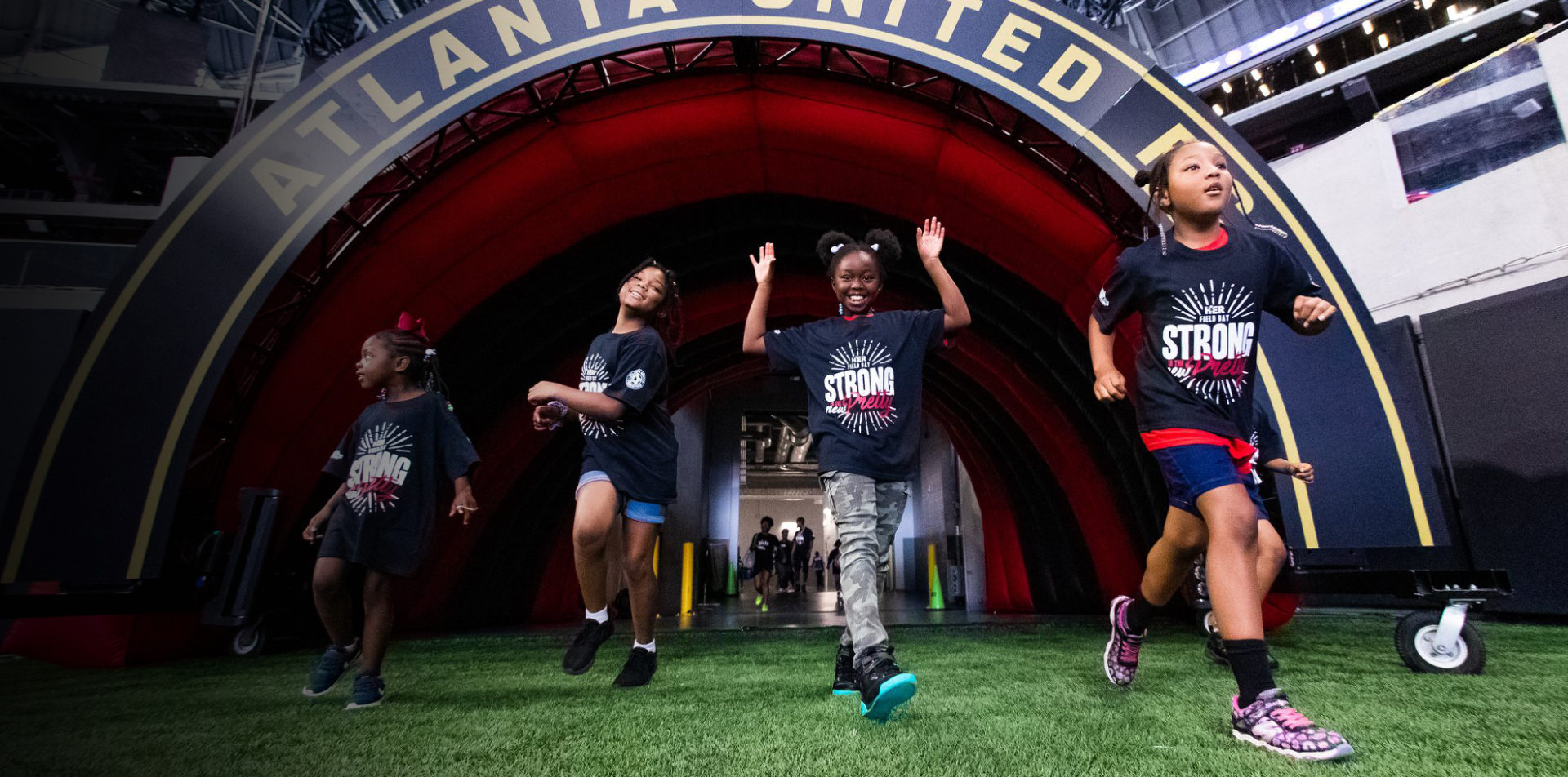 Girls Inc Atlanta running out of the Atlanta Mercedes Benz tunnel